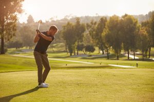 man golfer hitting a golf ball